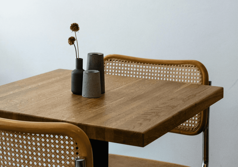 Wooden table with woven chairs.