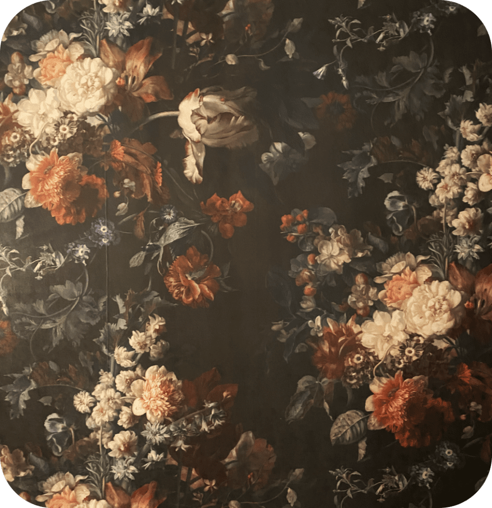 A floral vintage wallpaper with big colorful flowers and a black background.