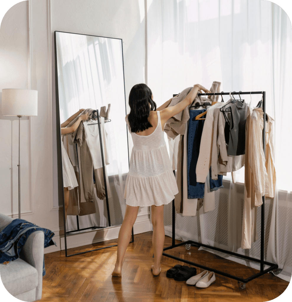 A woman sorting her clothes to color organize her closet.