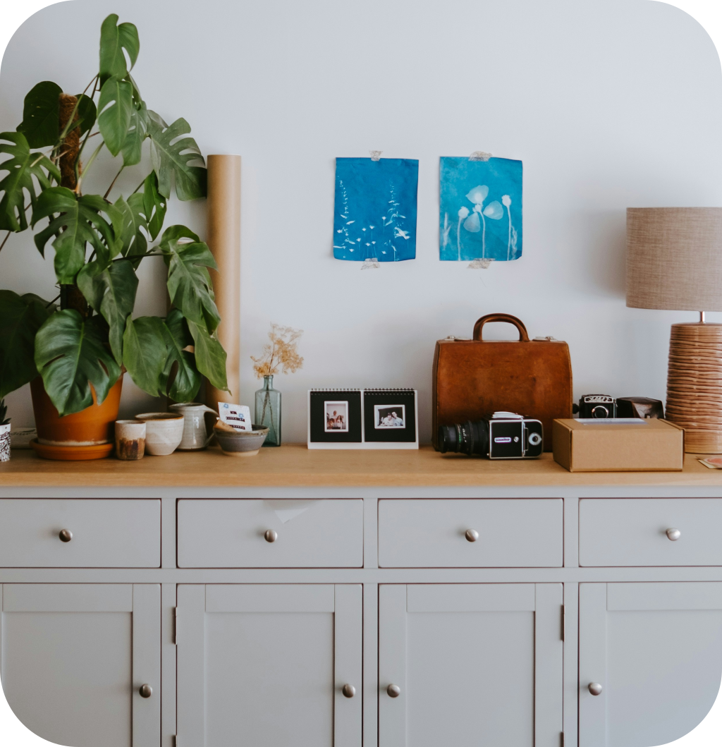 A white cabinet with decorations on top of it.