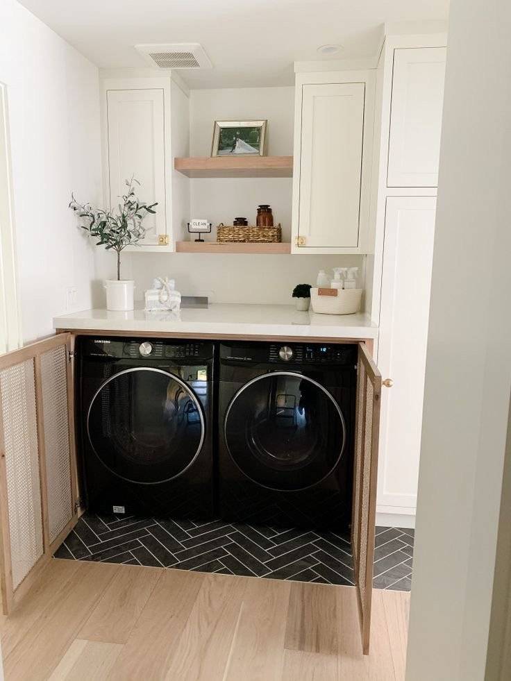 Two washing machines hiden behind cane cabinet doors.