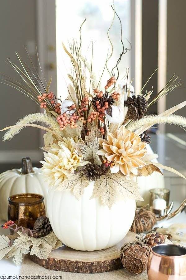 A fall arrangement with dried flowers, red berries and pine cones.