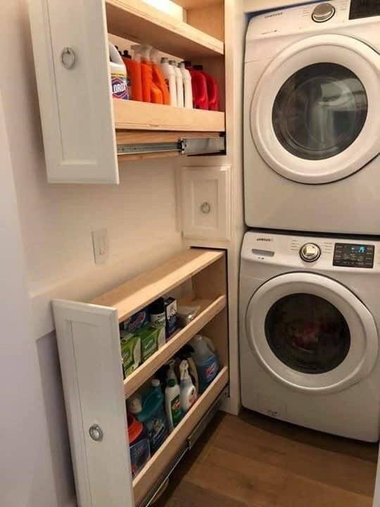 Vertical pull out drawers placed under wall and washing machines.