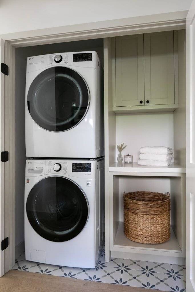 White and sage green laundry closet.