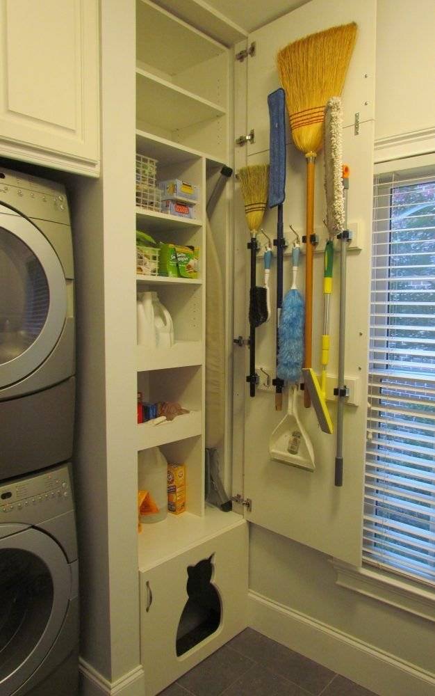 A broom holder on laundry closet door and a custom-made shelf.