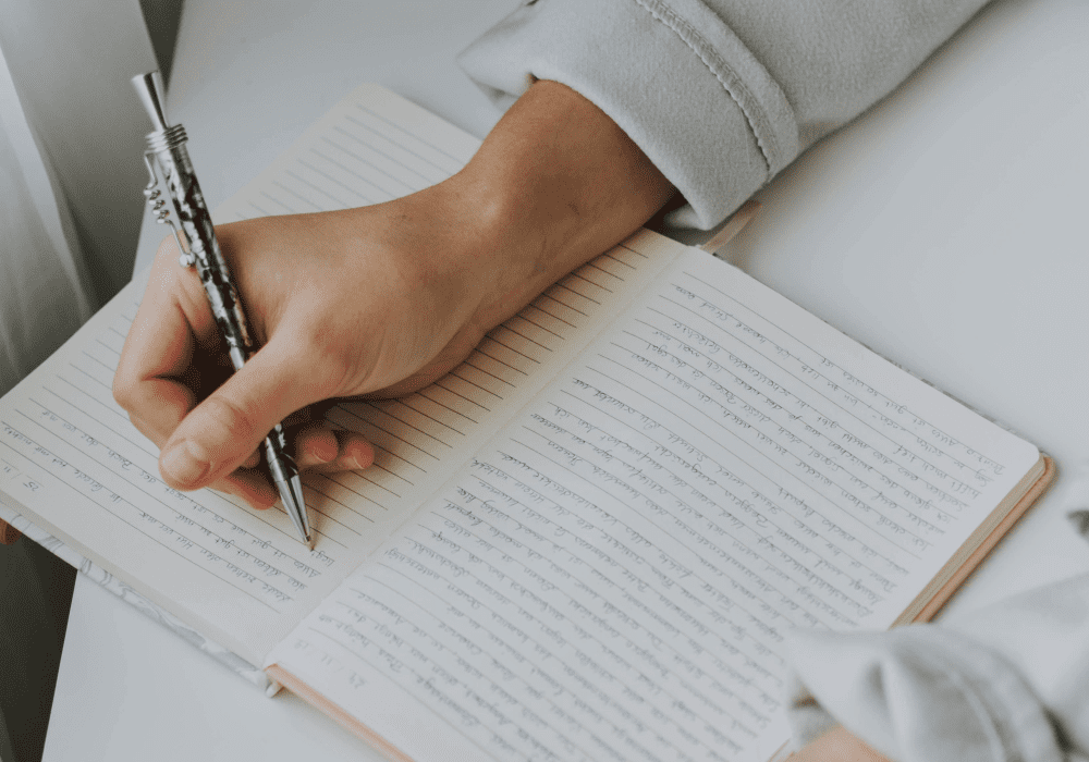 Woman writing on a notebook.