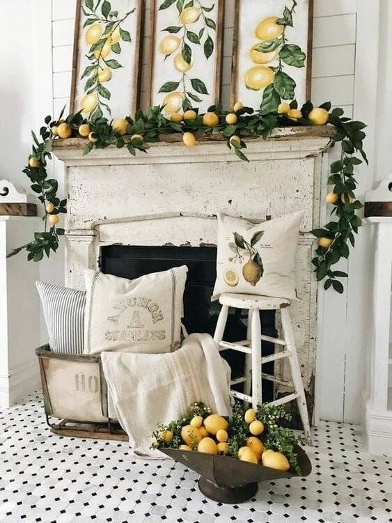 A mantel with a lemon garland and lemon frames.