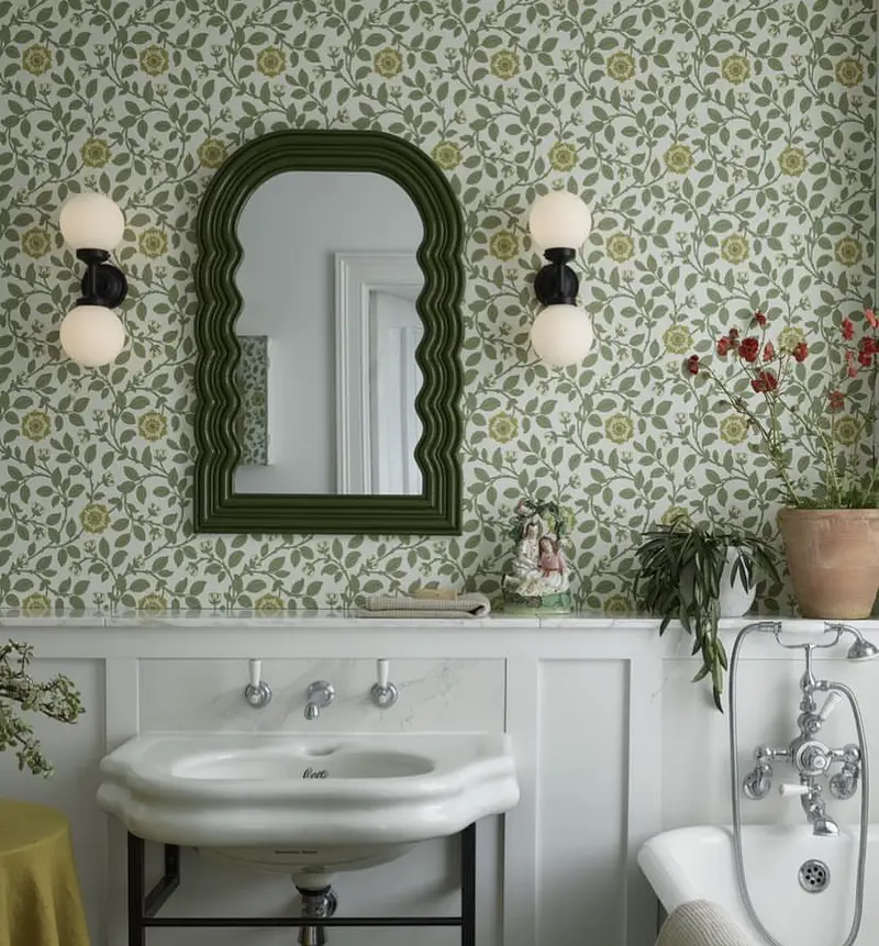 A green wavy retro mirror in a cottage bathroom.