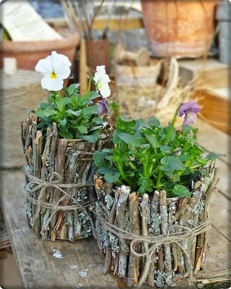 Flower pots decorated with little branches.