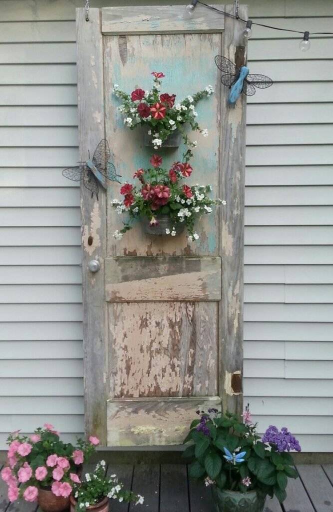 A decorative door with flowers and butterflies.