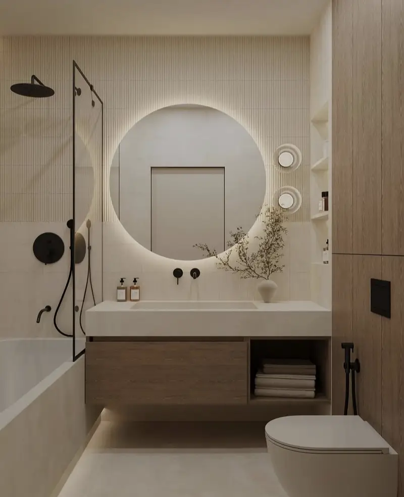 A frameless mirror in a contemporary and neutral bathroom.