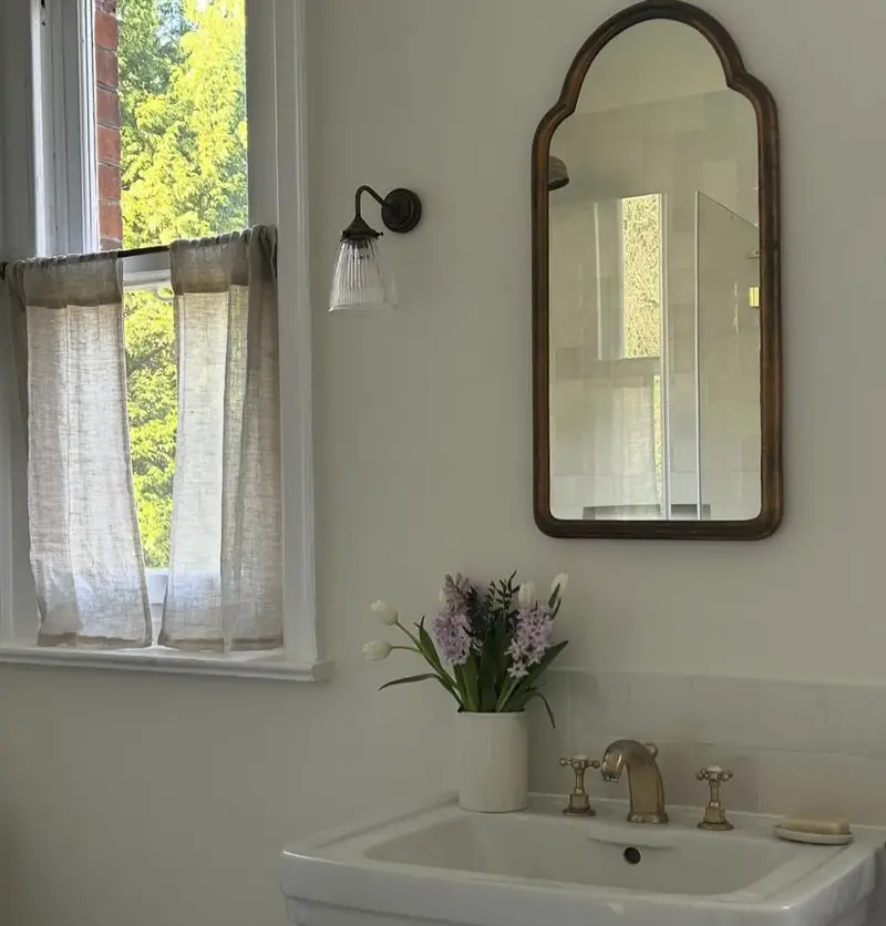 A wooden bathroom mirror.