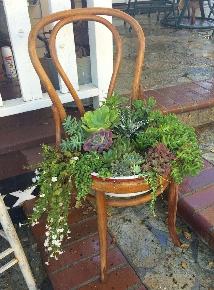 An old chair used as a flower planter.