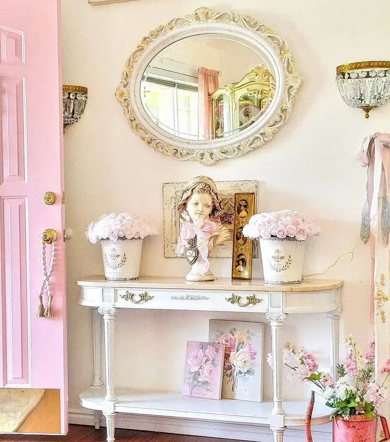An antique white mirror in a shabby chic entryway.