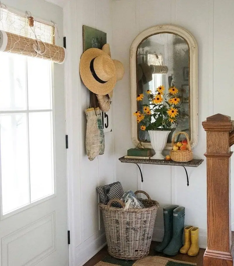 A white distressed mirror in a cottage core entryway.