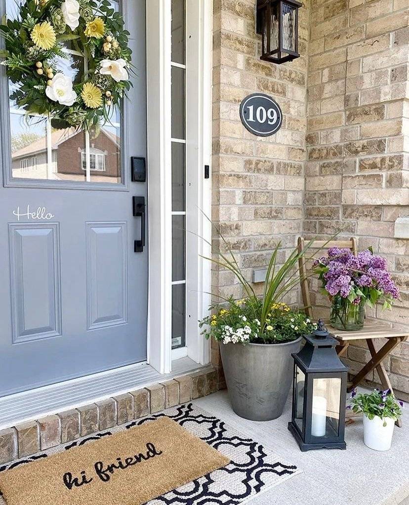 A gray door with a floral wreath.