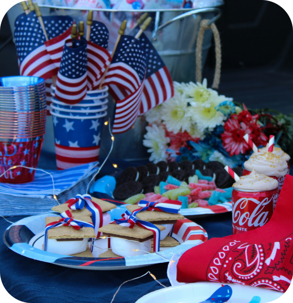 A table outside with cakes and sweets for the 4th of July.
