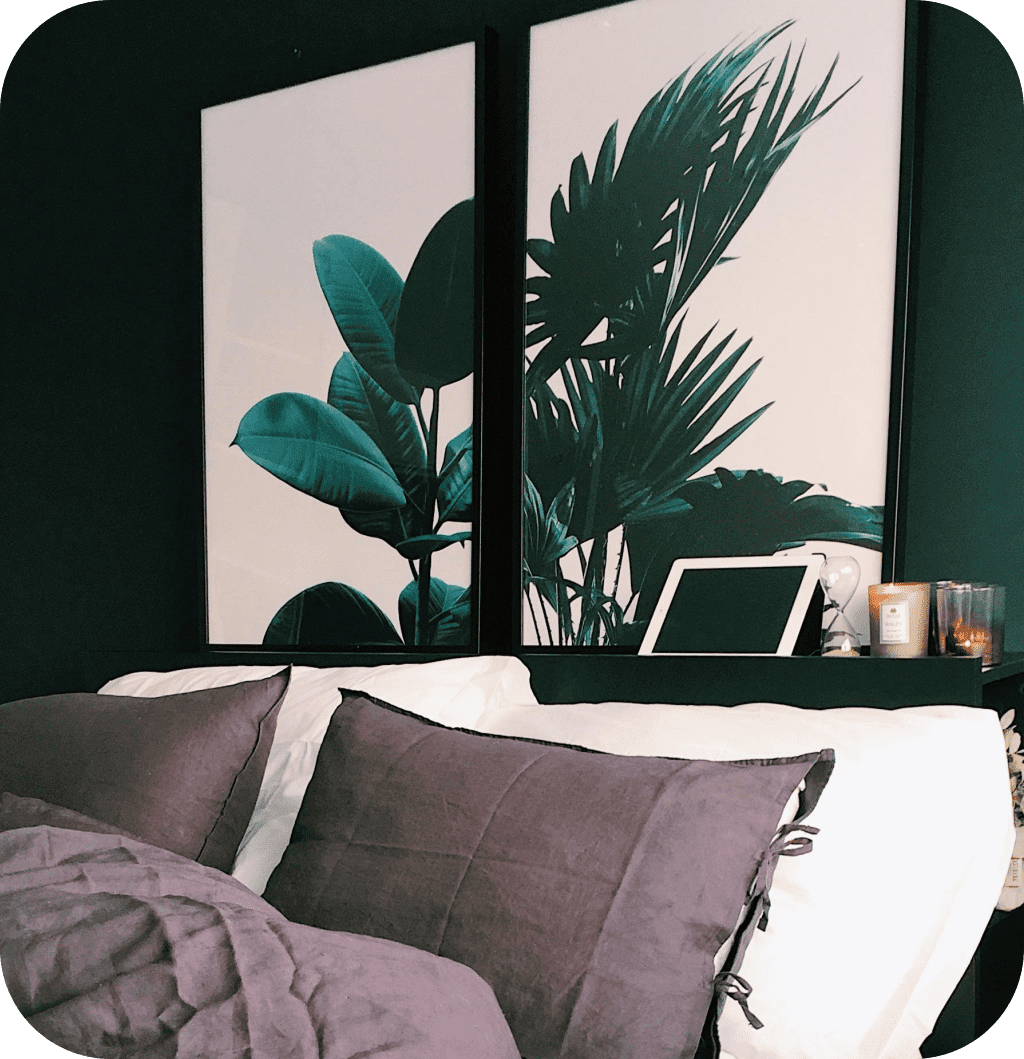 Two leaf canvas above a bed.