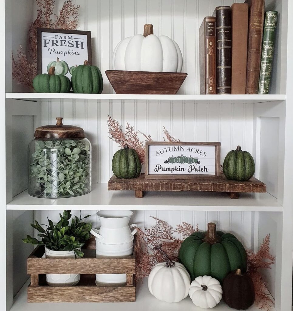 A green and brown fall decor on a shelf.