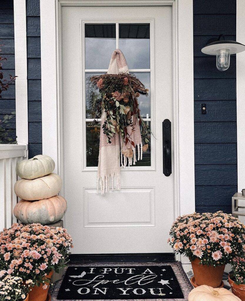 Pumpkins, chrysanthemums and a scarf on the door.