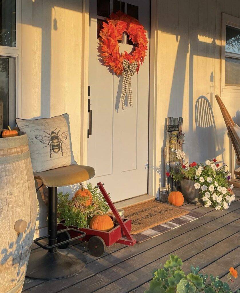 A bee pillow with pumpkins.