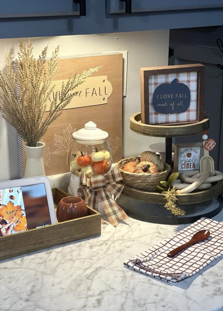 A fall tray with a fall jar filled with small pumpkins.