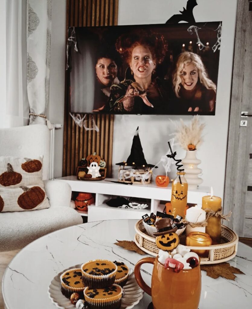 A Halloween living room with ghosts, pumpkins and witch hats.