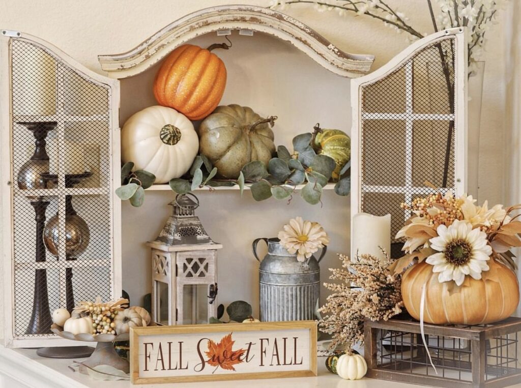 A distressed window with pumpkins.