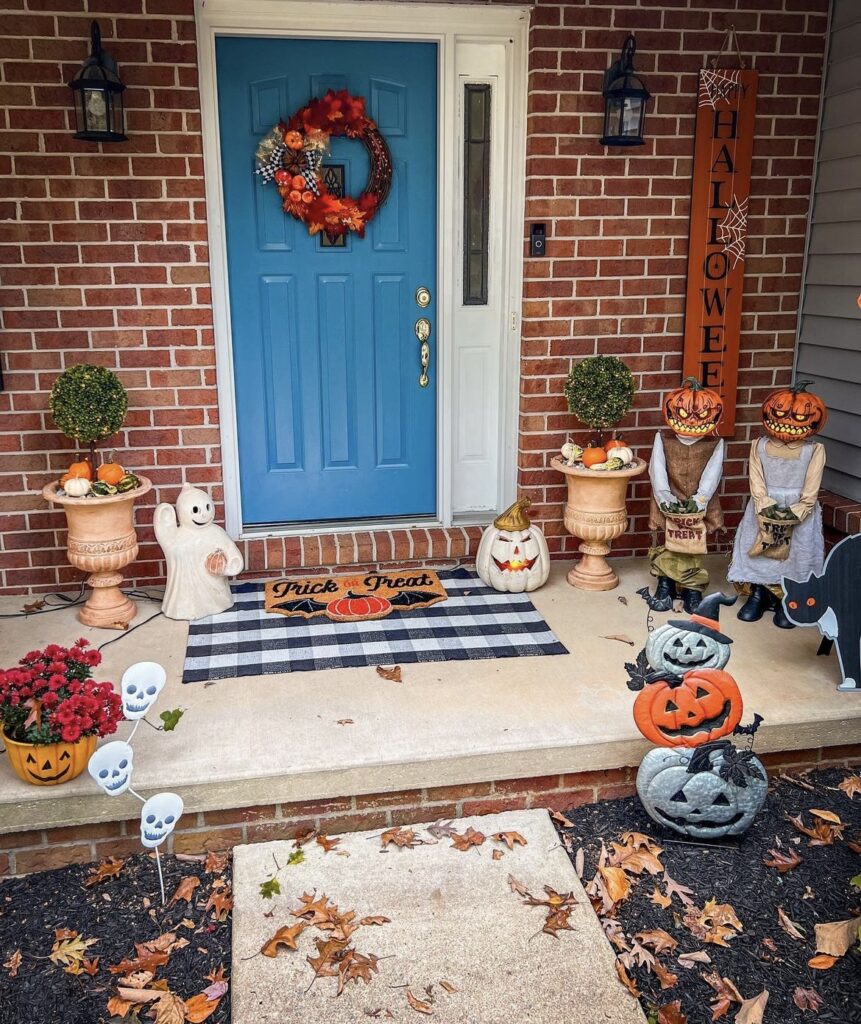 Halloween figurines on a porch.