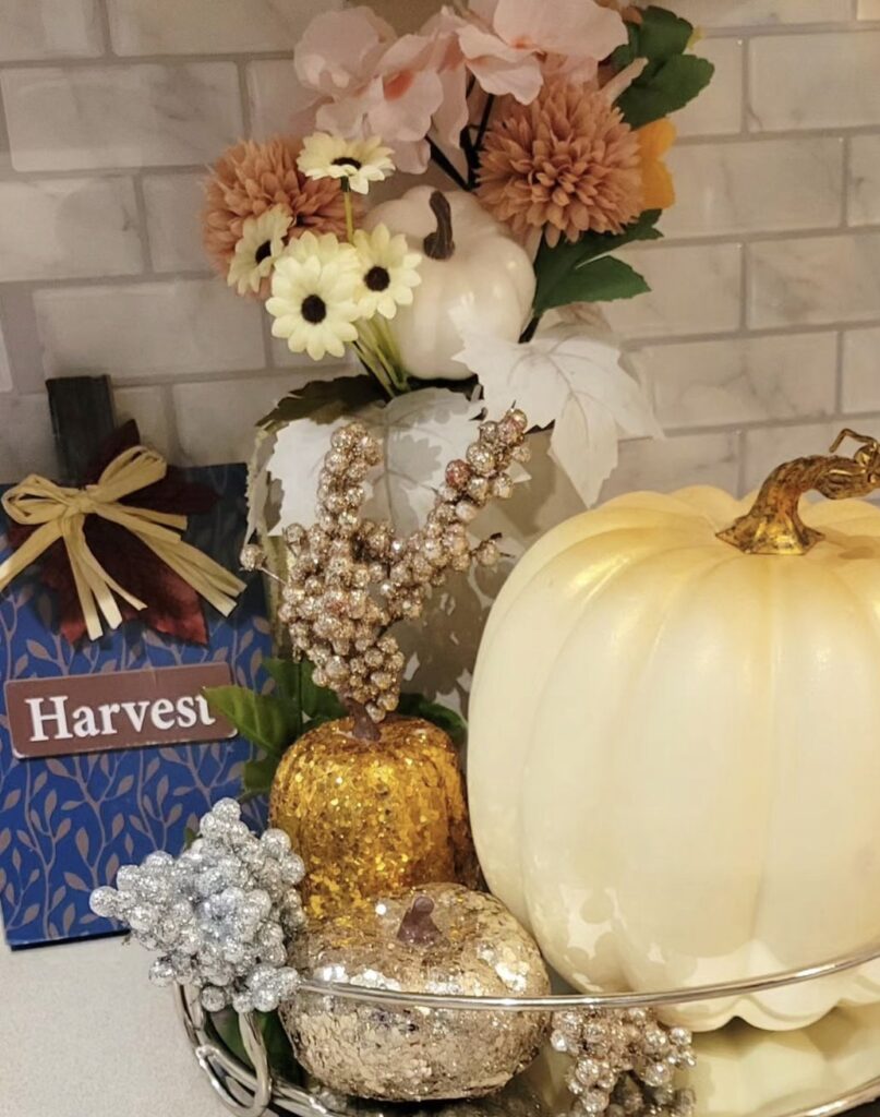 A kitchen fall tray filled with glitter pumpkins.