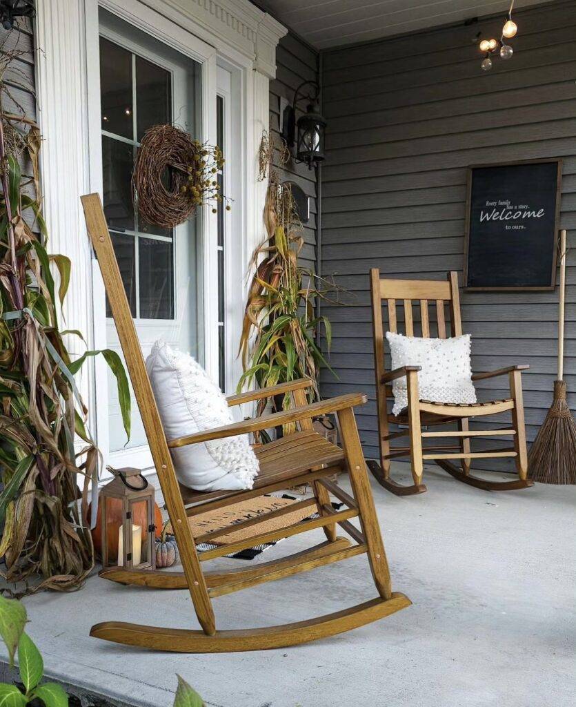 Cornstalks with a wooden wreath and pumpkins.