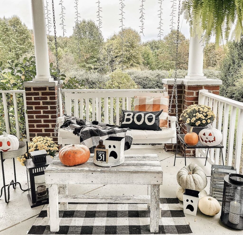 A farmhouse porch with pumpkins.