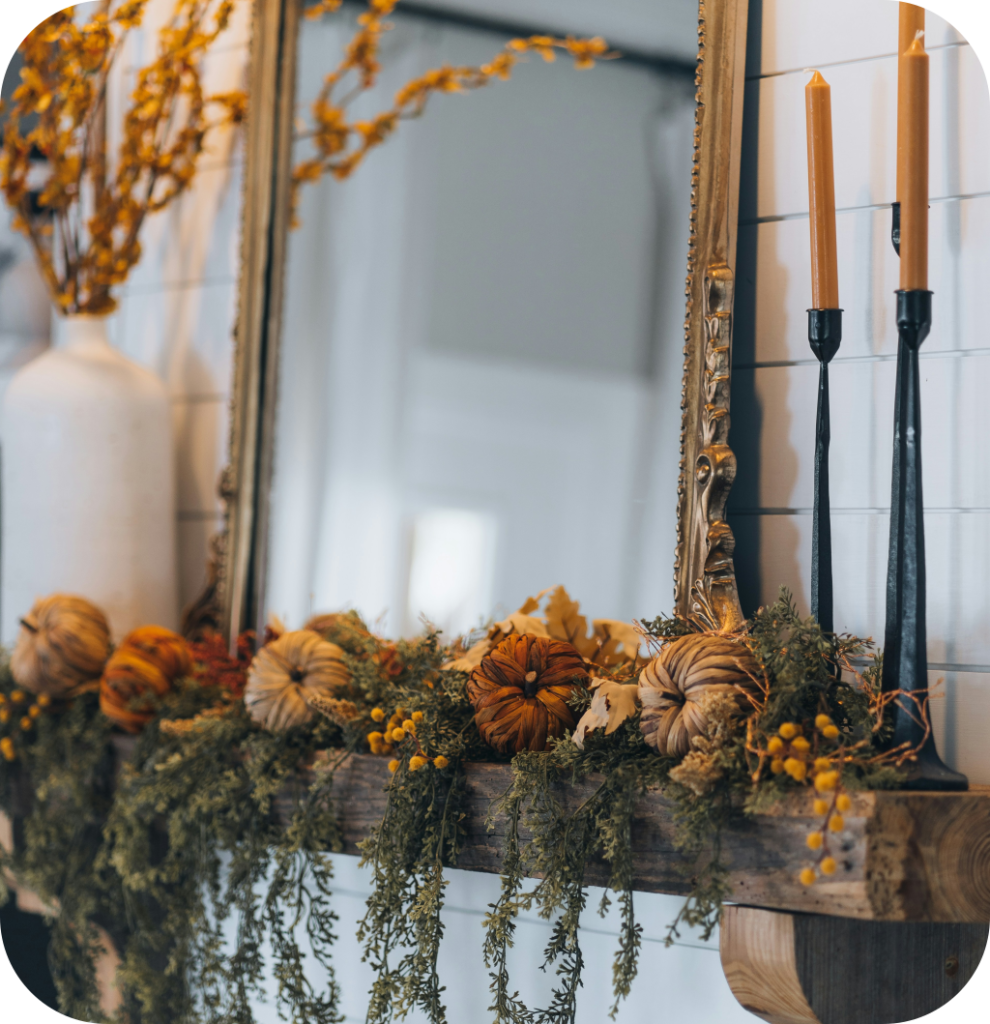 A mantel with a fall arrangement.