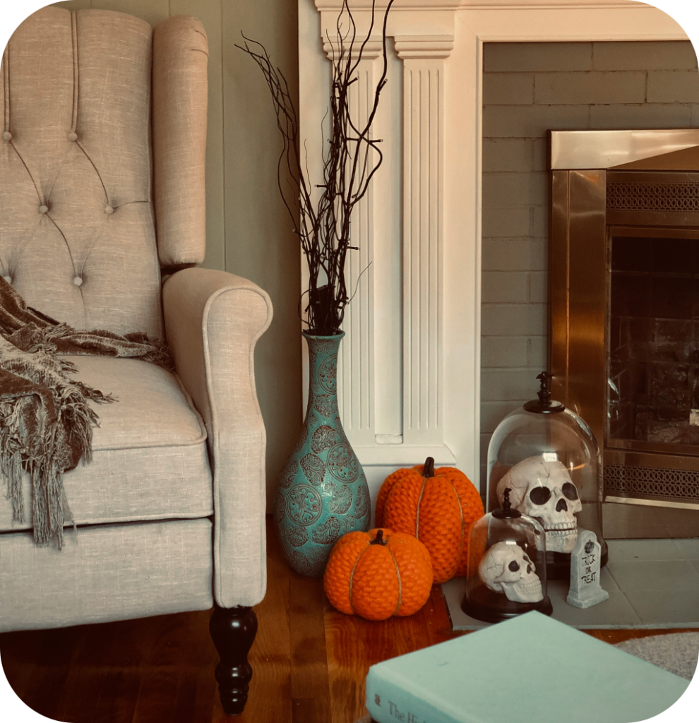 Pumpkins, skulls and branches in a living room.