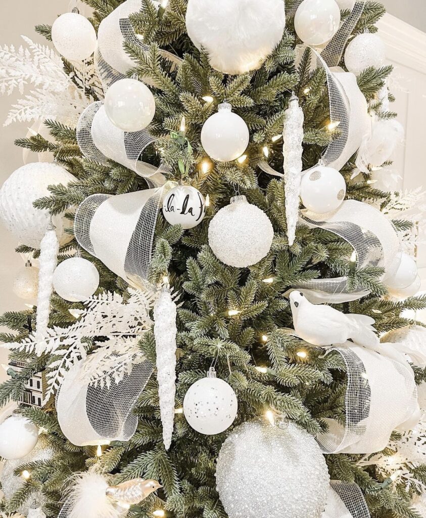 A white Christmas tree with doves and glitter leaves.