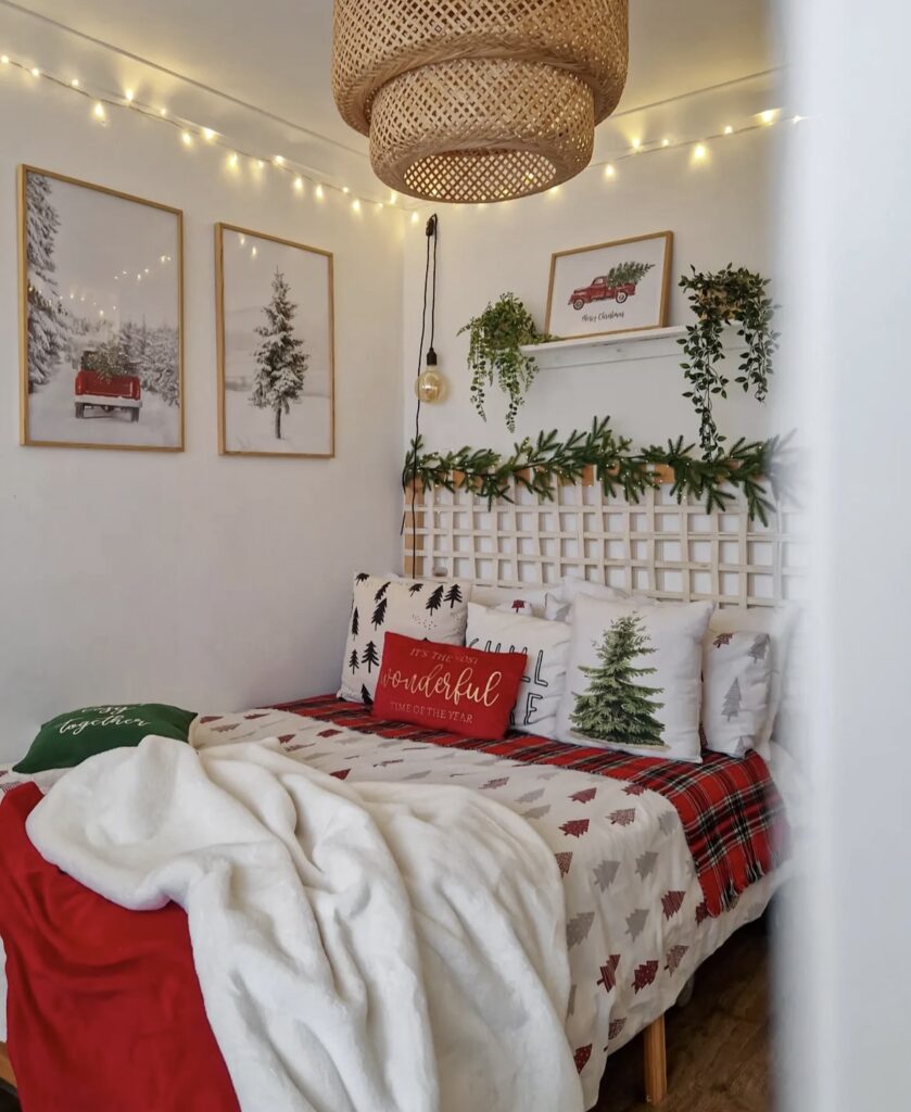 A bed with Christmas prints above it.