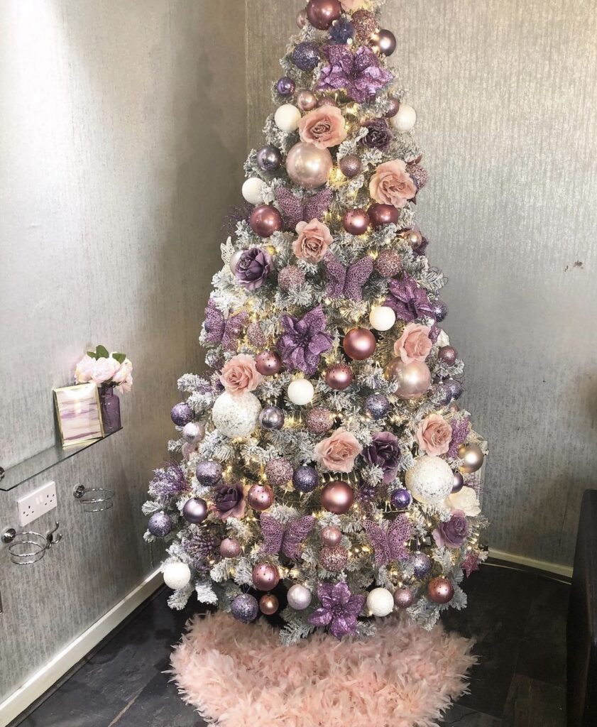 A purple Christmas tree with butterflies and roses.