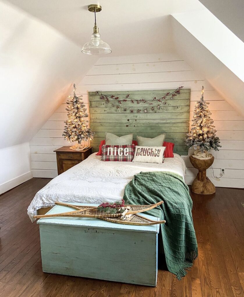 A green wooden headboard with Christmas garlands.