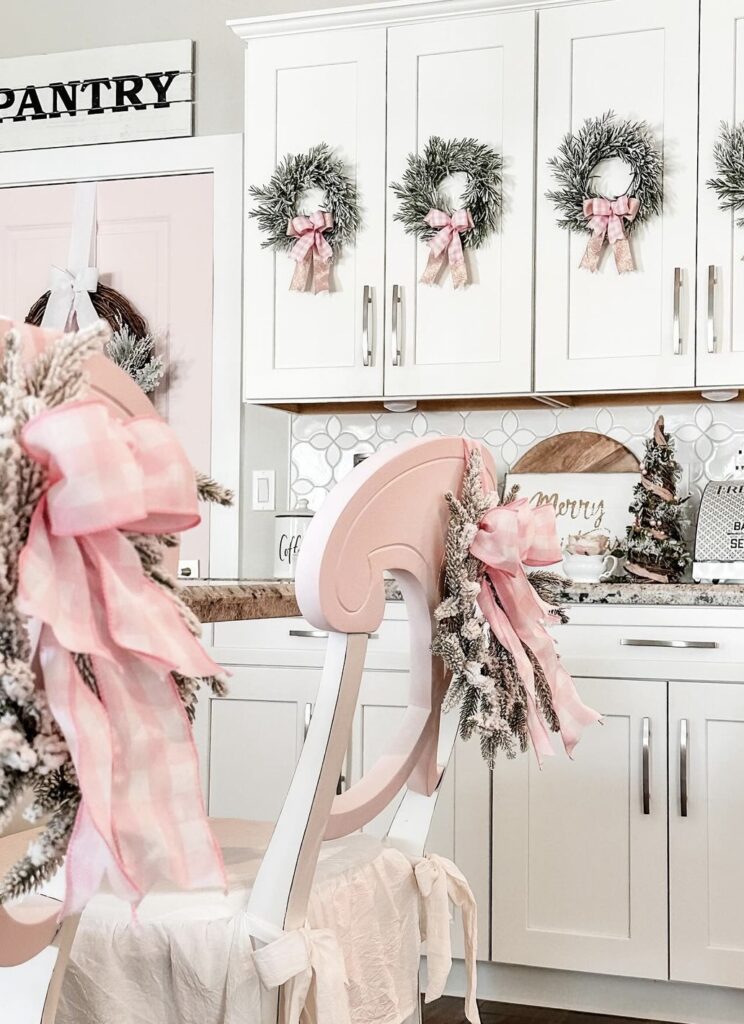 Pink ribbon bows on chair backs and kitchen cabinet doors.