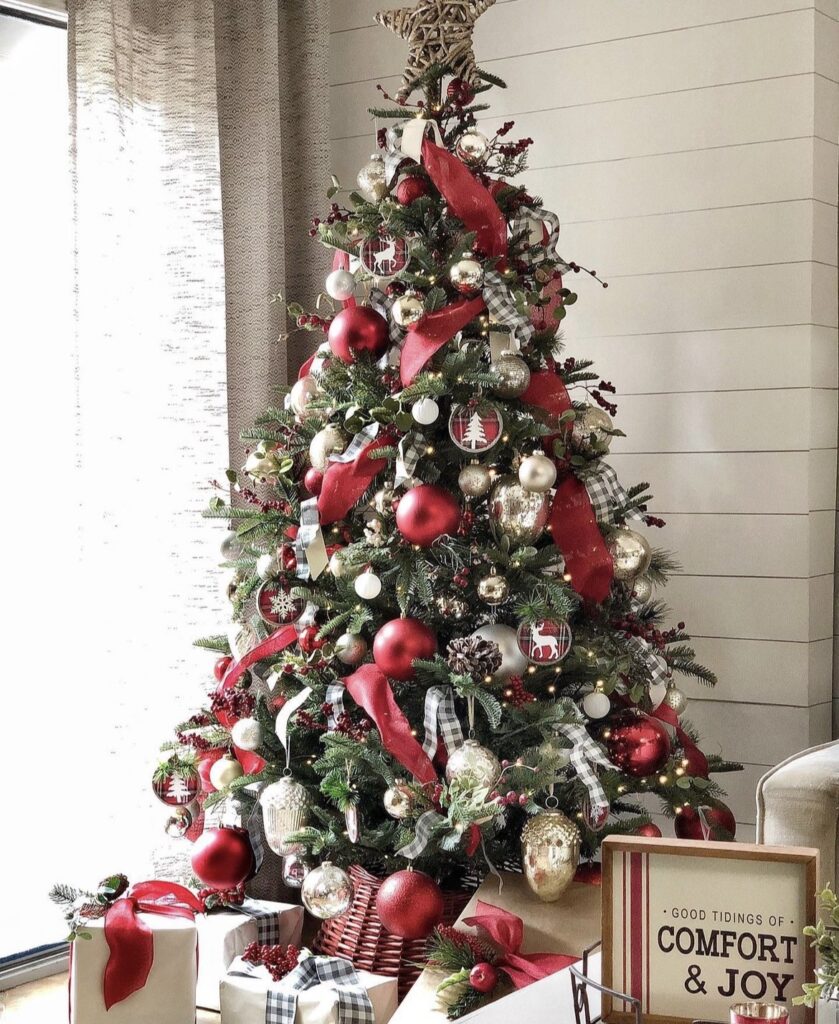 A red and gold Christmas tree with gold pine cones and red balls.