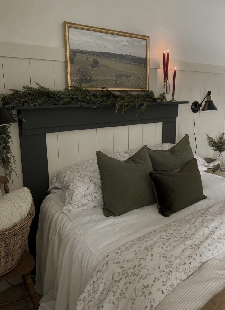 A pine branch garland on the headboard with red candles.