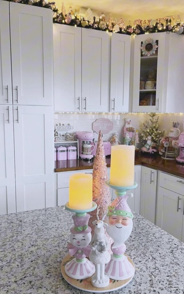 Pink Christmas decorations on a kitchen countertop.