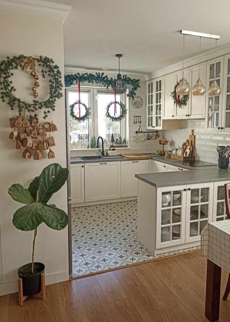 Jingle bells on a wreath in a kitchen.