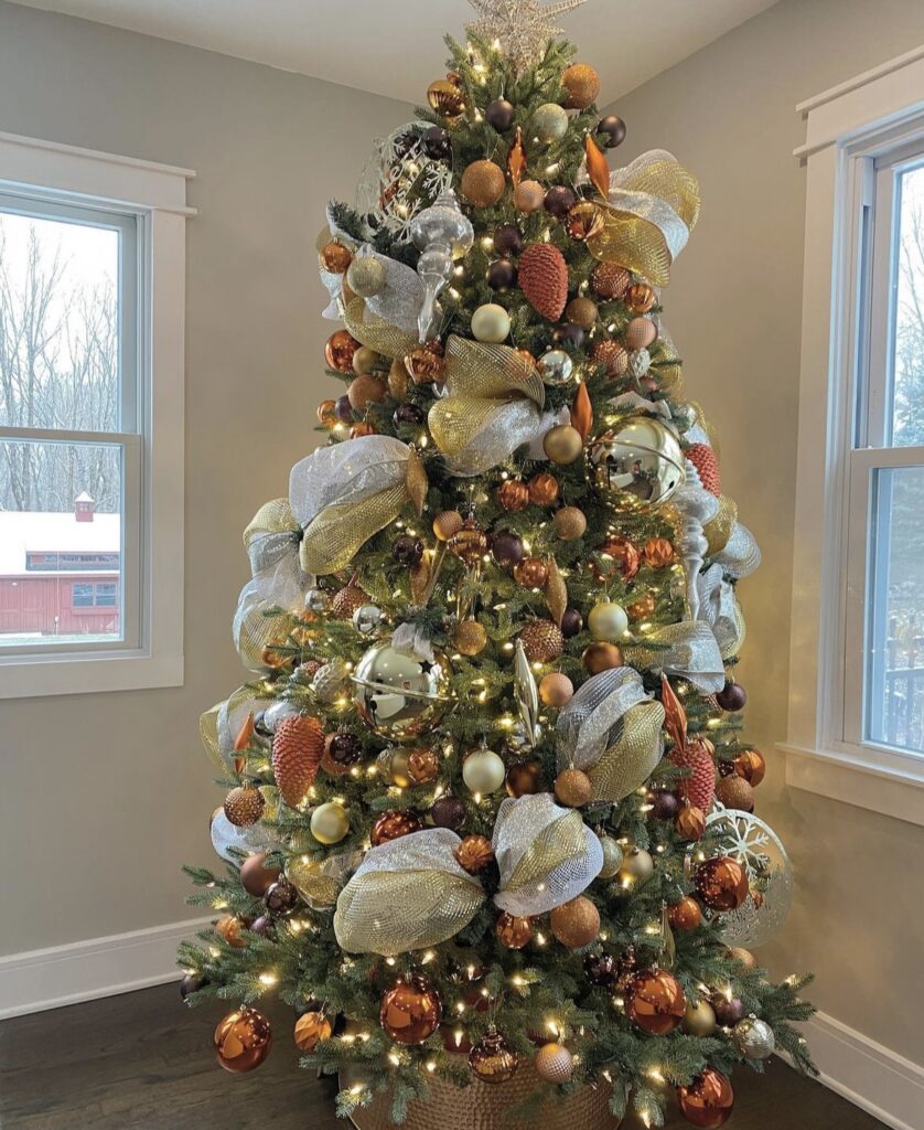 A copper Christmas tree with brown balls and copper finial ornaments.