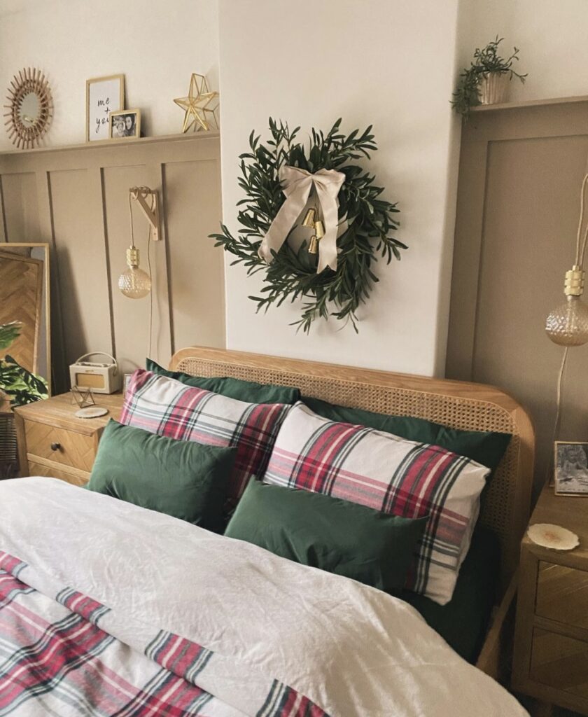 A Christmas wreath above the bed.