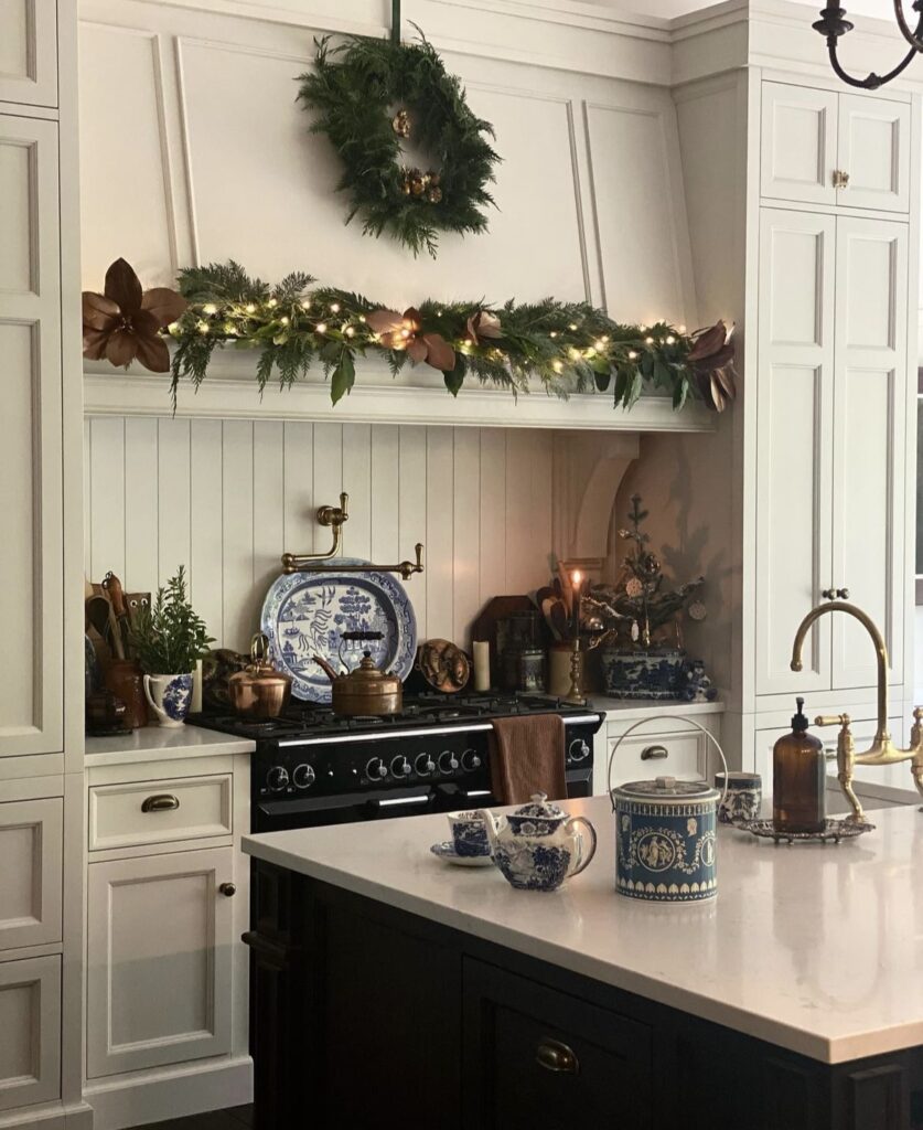 A pine garland and wreath on a kitchen hood.