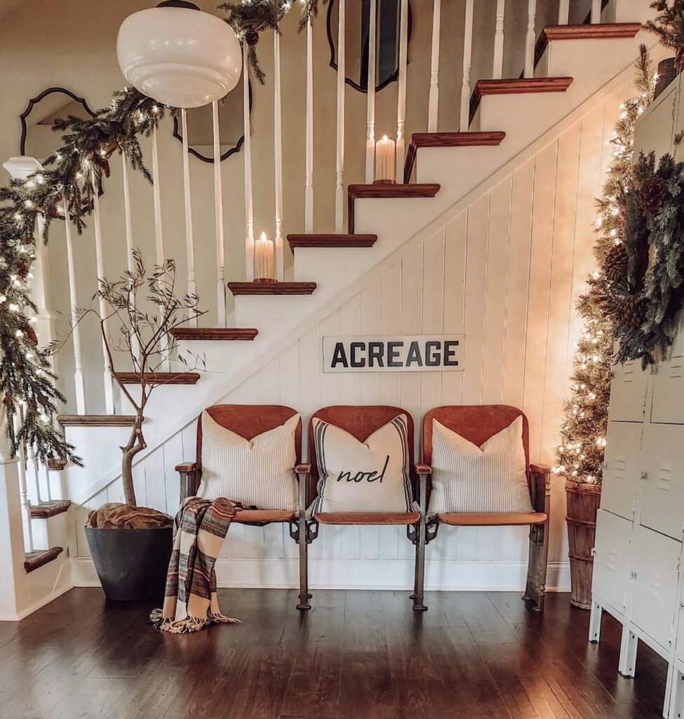 A pine garland with string lights on stairs’ handrail.