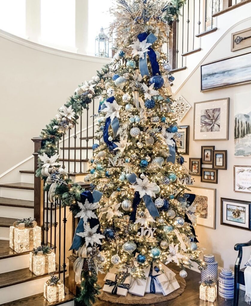 A blue and gold Christmas tree with blue berries and gold glitter leaves.