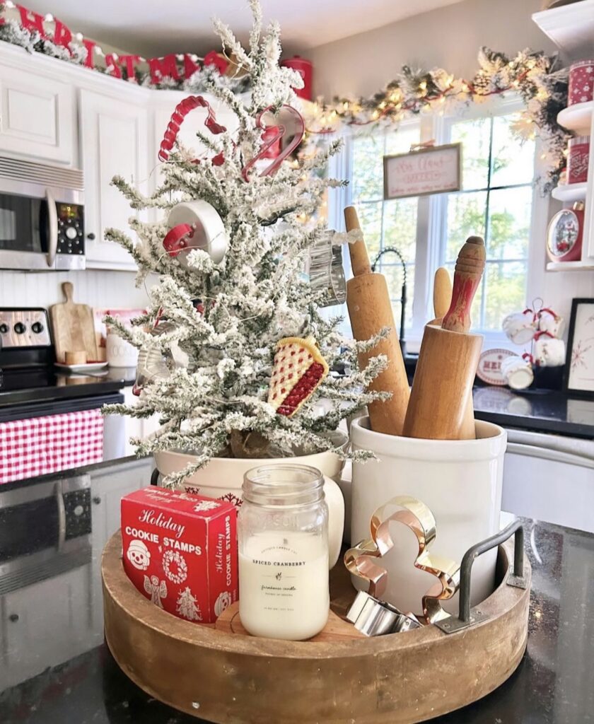 A Christmas garland on top of a kitchen cabinet.