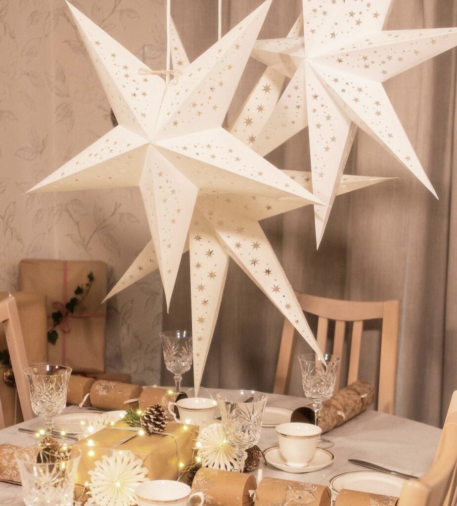 White paper stars with string lights inside.